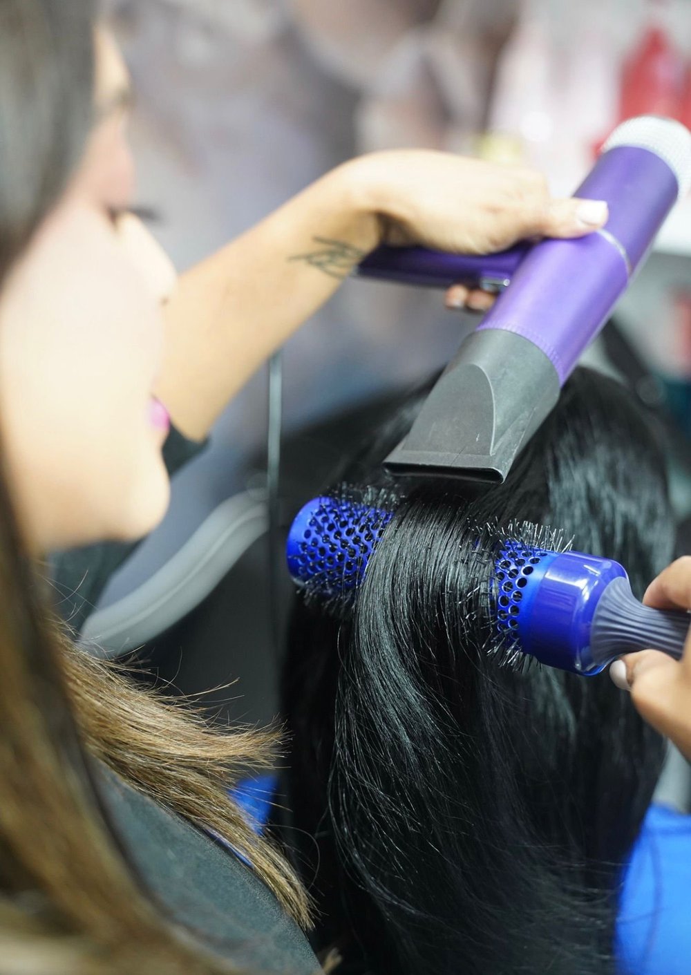 A guest receiving a blowout at Indulge Hair Lounge